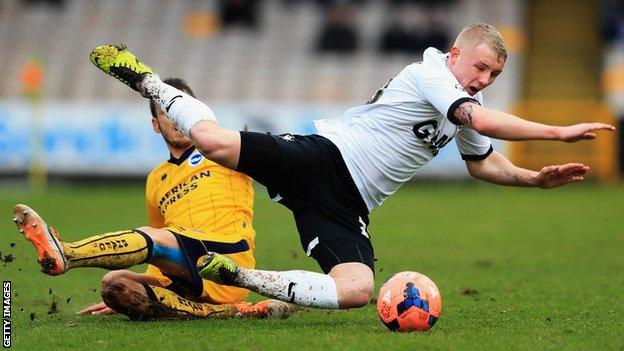 Andrea Orlandi [left] of Brighton & Hove Albion tackles Jack Grimmer of Port Vale