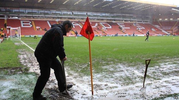 Groundsmen tend to the pitch at Sheffield United's Bramall Lane ground ahead of their FA cup tie with Fulham