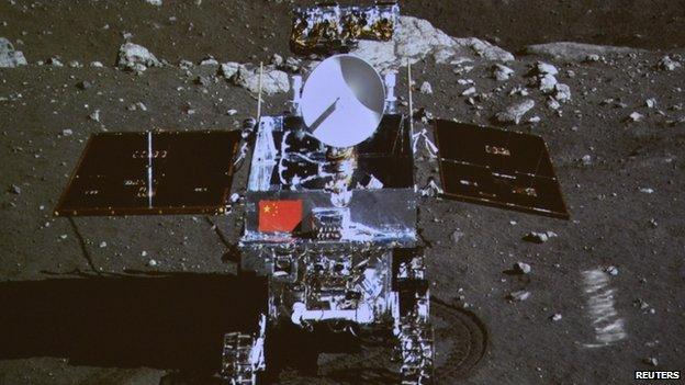 A photograph of the giant screen at the Beijing Aerospace Control Centre shows a photo of the Yutu, or "Jade Rabbit" lunar rover in Beijing, 15 December 2013