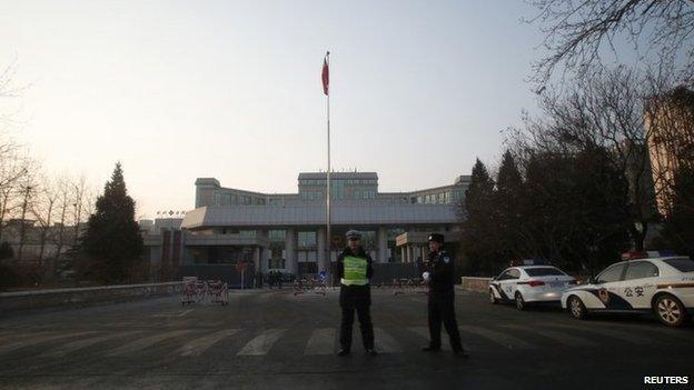 Policemen stand guard outside the Beijing No. 1 Intermediate People's Court, where Xu Zhiyong's trial is held, in Beijing, 26 January 2014