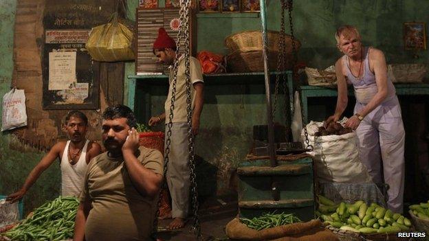 Vendors arrange vegetables at their stalls at a wholesale market in Mumbai