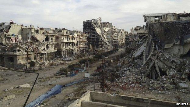 Damaged buildings and debris are pictured in the besieged area of Homs on 24 December 2013