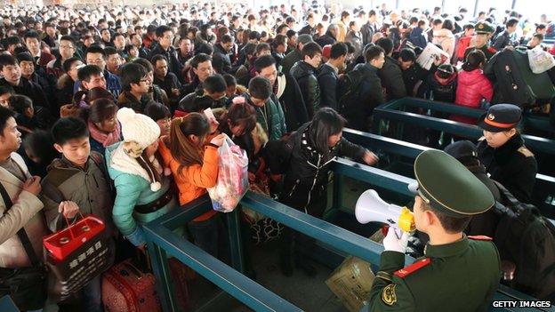 Passengers wait for trains at Beijing West Railway Station on 26 January 2014