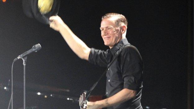 Canadian musician Bryan Adams waves to the crowd before performing at the Harare International Conference Centre in Zimbabwe - 24 January 2014