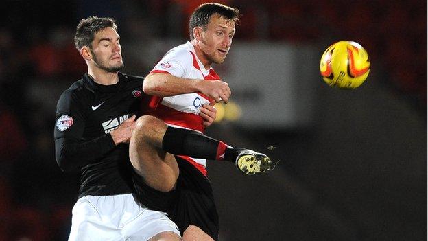 Doncaster Rovers player Chris Brown battles for the ball