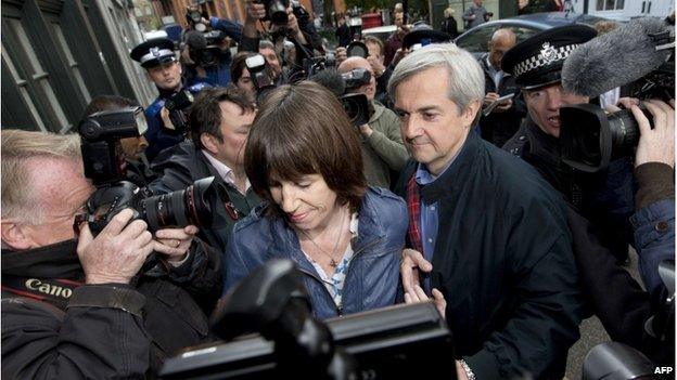 Chris Huhne and partner Carina Trimingham surrounded by photographers on his release from prison
