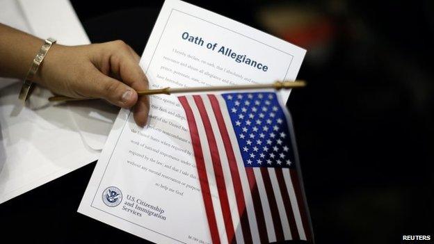 A woman holds the Oath of Allegiance at a naturalisation ceremony in Los Angeles