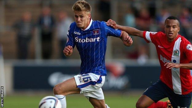 Carlisle United defender Brad Potts (centre) grapples with Blackburn Rovers defender Markus Olsson (right)