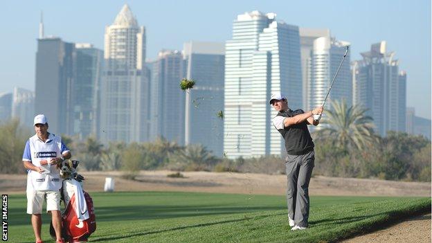 McIlroy watches his shot on the 10th hole on Thursday