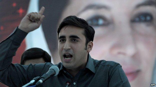 Bilawal Bhutto Zardari, the chairman of the Pakistan Peoples Party addresses supporters in front of a poster of his mother, slain Prime Minister Benazir Bhutto, at a rally in Karachi on 30 November 2013