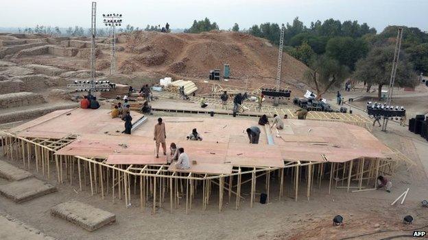 Pakistani workers prepare a stage around the ancient ruins, ahead of the Sindh Festival opening ceremony in Mohenjo Daro