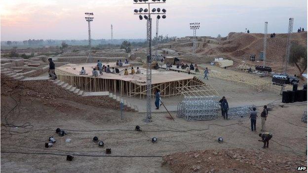 Pakistani workers prepare a stage around the ancient ruins, ahead of the Sindh Festival opening ceremony in Mohenjo Daro