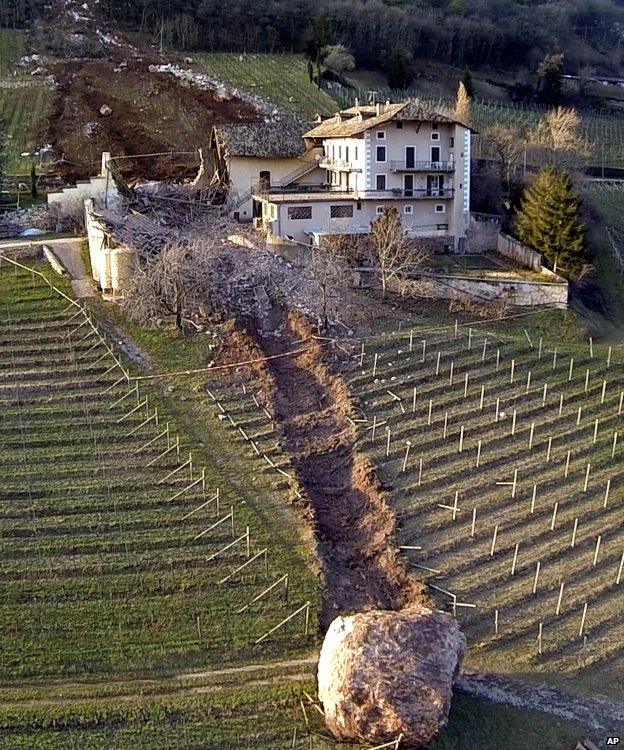 Boulder seen by farm house