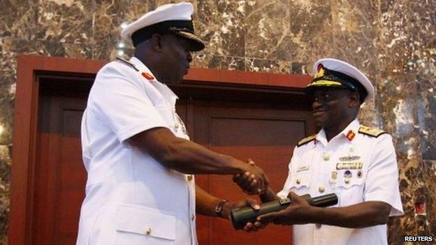 New Chief of Naval Staff, Rear Admiral Usman O. Jibrin (L), receives a periscope from the outgoing Vice Admiral Dele Joseph Ezeoba during a handing over ceremony at the Defence Ministry headquarters in Abuja January 20, 2014.