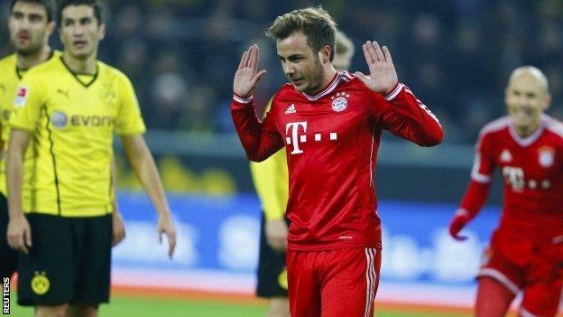 Bayern Munich's midfielder Mario Gotze gestures after scoring the 0-1 during the German first division Bundesliga football match between Borussia Dortmund and Bayern Munich