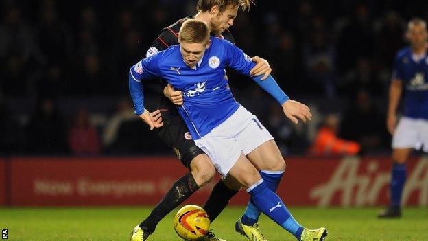 Leicester City's Martyn Waghorn and Reading's Kaspars Gorkss (behind) battle for the ball