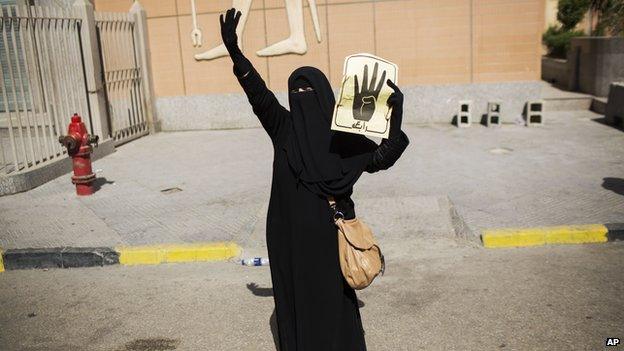 A supporter of Egypt's ousted President Mohammed Morsi holds a placard during a protest following Friday Muslim prayers at Nasser City in Cairo, Egypt (Aug. 30, 2013)