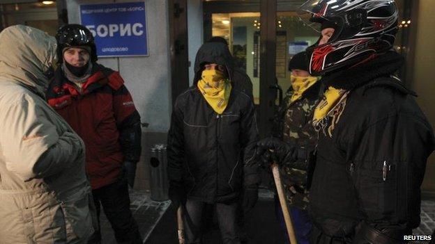 Opposition activists stand guard near the entrance to a private hospital where activist Dmytro Bulatov is being treated in Kiev, Ukraine, 31 Jan