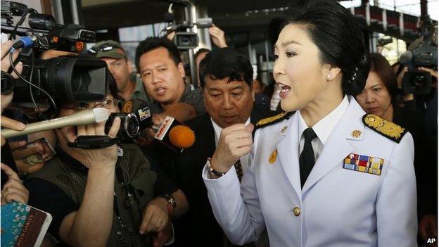 Yingluck Shinawatra speaks to media as she leaves a meeting with election commissioners at the Army Club, Tuesday, Jan. 28