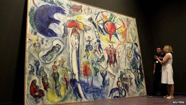 Museum staff with Chagall's painting "Life" in the Hungarian National Gallery in 2013