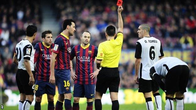 Referee shows a red card to FC Barcelona's Jordi Alba