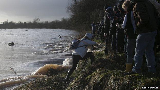 A woman climbing out of the way of the Severn Bore