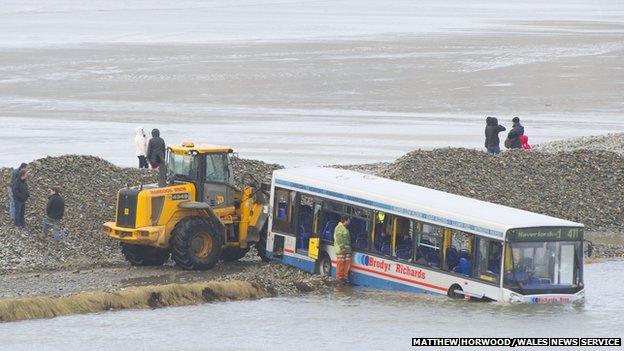 Council workers cleared the road near the stranded bus on Sunday