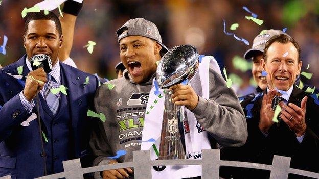 Outside linebacker and Super Bowl MVP Malcolm Smith of the Seattle Seahawks holds the Vince Lombardi Trophy