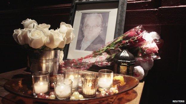 Flowers and candles are laid at a memorial for actor Philip Seymour Hoffman