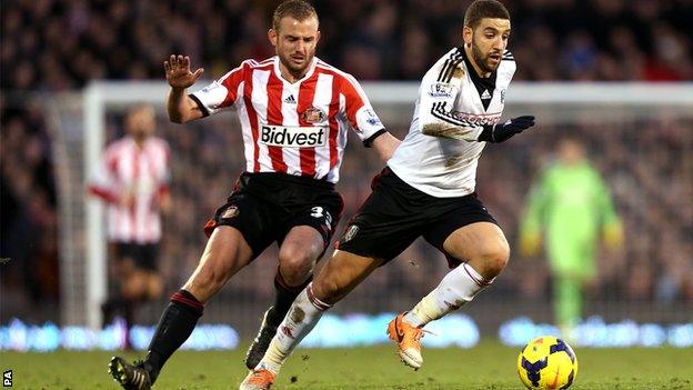 Sunderland midfielder Lee Cattermole (left) challenges Fulham's Adel Taarabt