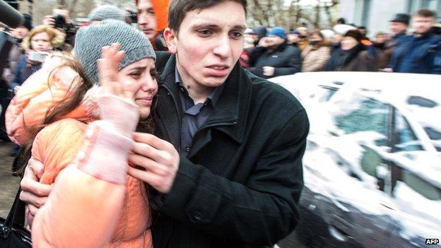 A student at the school walks out of the school with a relative