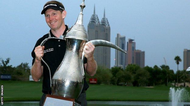 Stephen Gallacher lifts the trophy for the second year running