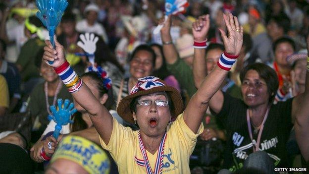 Anti-government protestors cheer as leader Suthep Thaugsuban speaks about the elections during his daily speech 3 February 2014 in Bangkok,Thailand