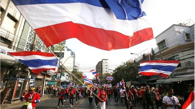 Anti-government protesters march through the streets of the Chinatown area of Bangkok on 1 February 2014