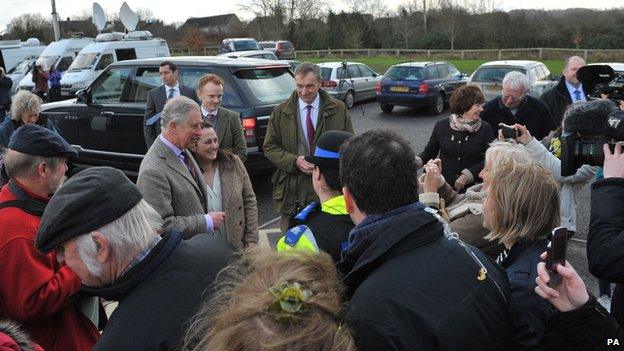 Prince Charles arrives at the Williams Hall in Stoke St Gregory, Somerset, to meet local residents and emergency service workers