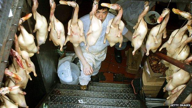 Worker in a restaurant basement, Chinatown, New York, 2002