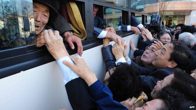 File photo: North Koreans (in the bus) grip hands of their South Korean relatives as they bid farewell following their three-day separated family reunion meeting at Mount Kumgang resort, North Korea, 1 November 2010