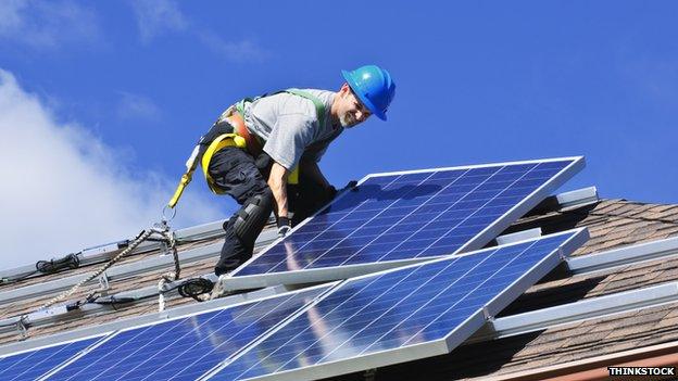 A man installing solar panels