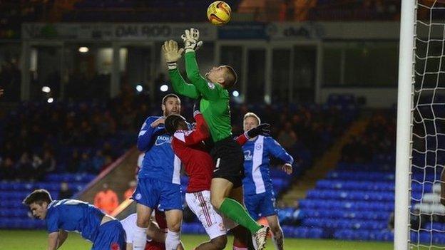 Bobby Olejnik of Peterborough United saves from Nile Ranger of Swindon Town