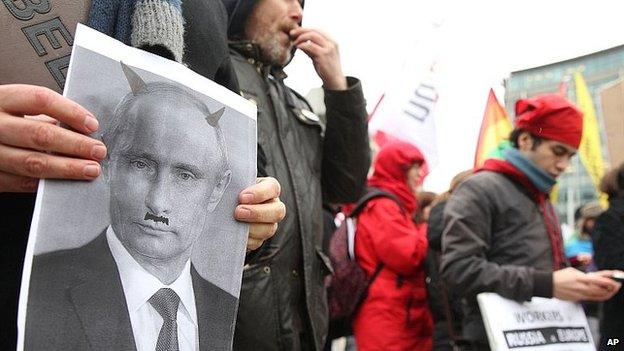 Gay rights protest in Brussels with photo of Vladimir Putin as a devil