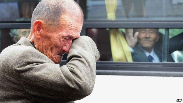 File photo: An elderly South Korean man wipes his tears as a North Korean relative [in the bus] waves to say good-bye after a luncheon during a separated family reunion meeting at the Mount Kumgang resort on the North's southeastern coast, 31 October 2010