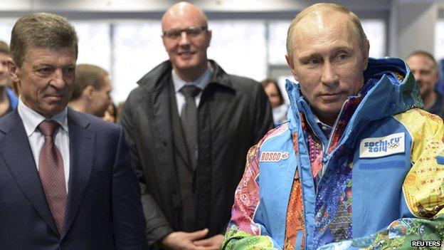 Russia's President Vladimir Putin (R), Organising Committee Head Dmitry Chernyshenko (C) and Deputy Prime Minister Dmitry Kozak (L) visit an Olympic volunteers centre in Sochi on 4 January 2014.