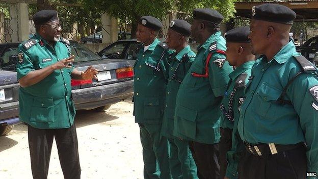 Jibrin Danlami Hassan (left) speaks to police colleagues. Mr Hassan is leading the local Islamic police campaign against homosexuals in Bauchi