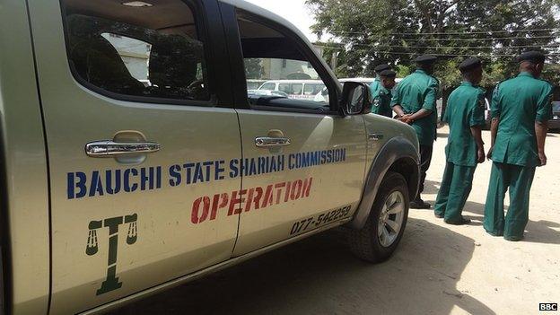 A Bauchi State Sharia Commission vehicle, alongside some officers of the same organisation