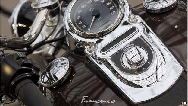 The 1,585 cc Harley Davidson Dyna Super Glide, donated to Pope Francis last year and signed by him on its tank, is displayed as part of Bonham"s Les Grandes Marques du Monde vintage and classic cars sale at the Grand Palais in Paris