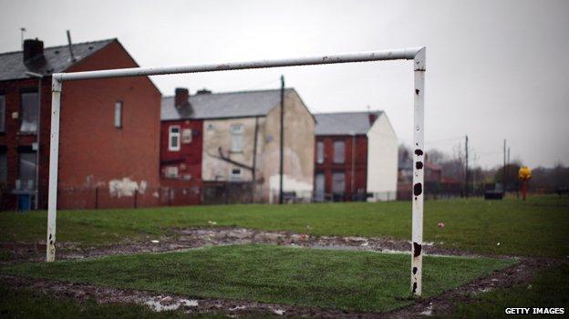 Goalposts on a pitch near homes