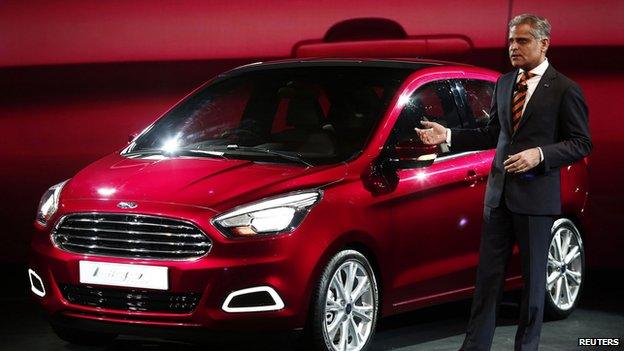 Kumar Galhotra, vice-president, engineering, Ford Motors, stands next to a Ford Figo concept car at the India motor show 2014