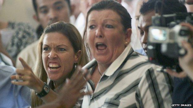 Schapelle Corby's mother, Roseleigh Rose (C), and sister Mercedes Corby shout as her daughter is sentenced to 20 years in jail in Bali on 27 May 2005