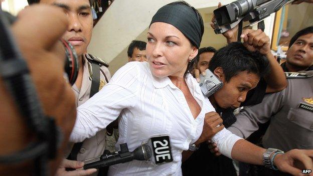 Schapelle Corby is escorted by police to a court room in Bali island on 25 August 2006