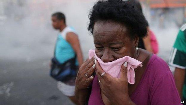 Woman covers her face outside the train station in Rio, Brazil